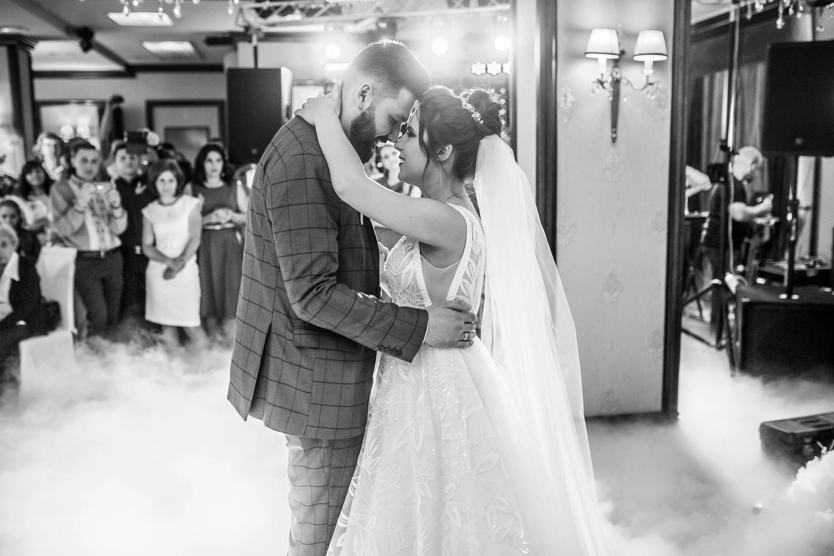 Wedding Dj and the first dance bride and groom with a romantic emotional pose.