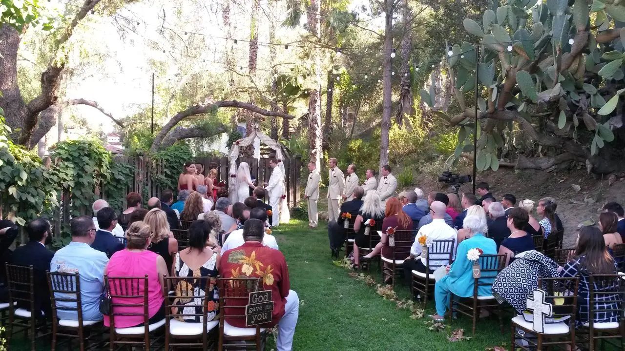 Outdoor Wedding Ceremony Best Wedding Dj ceremony with bride, groom, bridesmaids and groomsmen, guests seated.