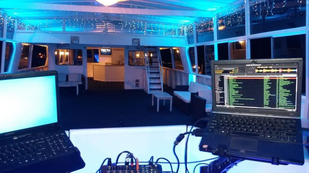 Birthday Karaoke Dj on a boat by Mr Dj Services with two lap tops for party dj music, karaoke and atmosphere up lighting