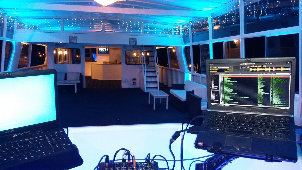 Birthday Karaoke Dj on a boat by Mr Dj Services with two lap tops for party dj music, karaoke and atmosphere up lighting