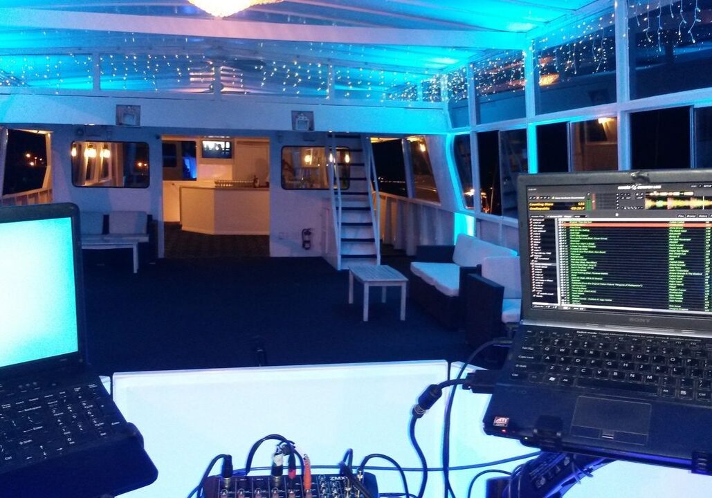 Birthday Karaoke Dj on a boat by Mr Dj Services with two lap tops for party dj music, karaoke and atmosphere up lighting